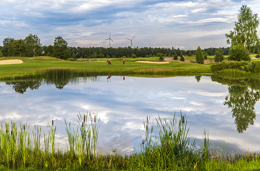 golf course landscape with beautiful lake at summer day
