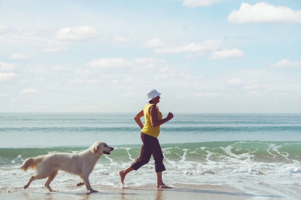 istock Elderly woman running with her golder retriever 1223391109