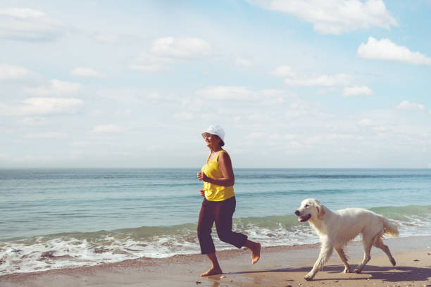 istock Elderly woman running with her golder retriever 1223391154