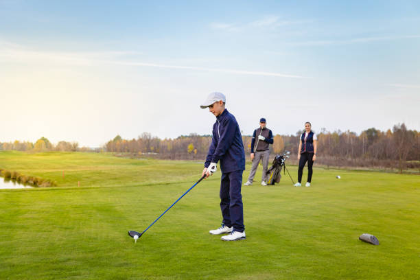 Happy family is playing golf in autumn stock photo