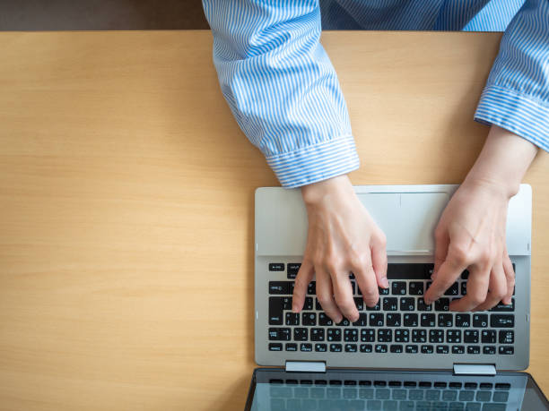 istock Overhead view of Asian woman using computer 1223391415