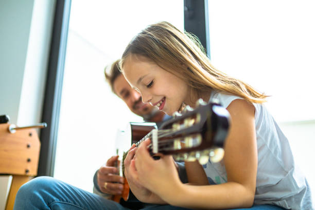 istock Father and kids playing guitar 1223392028