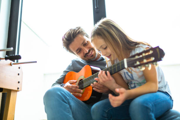 istock Father and kids playing guitar 1223392148