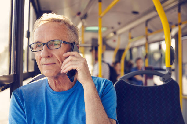 istock Senior man talking on smart phone in public bus 1223394319