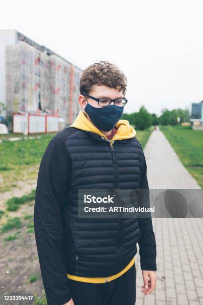 Cute Sad Teen Boy In Linen Cloth Homemade Face Mask During Corona Virus Pandemic In Warsaw Poland Stock Photo - Download Image Now