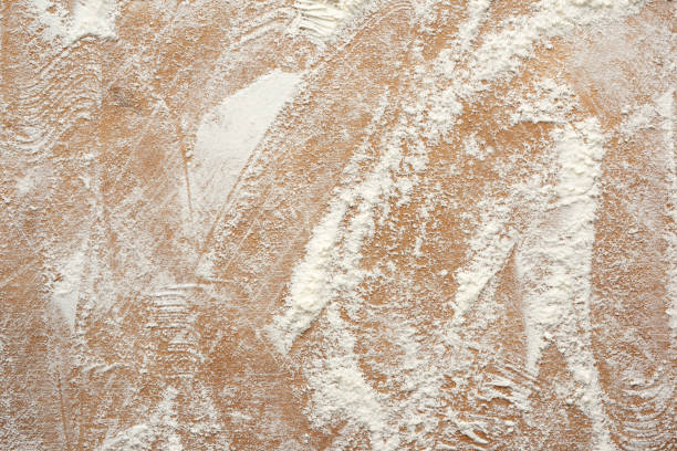 istock white wheat flour scattered on a brown wooden table 1223395054