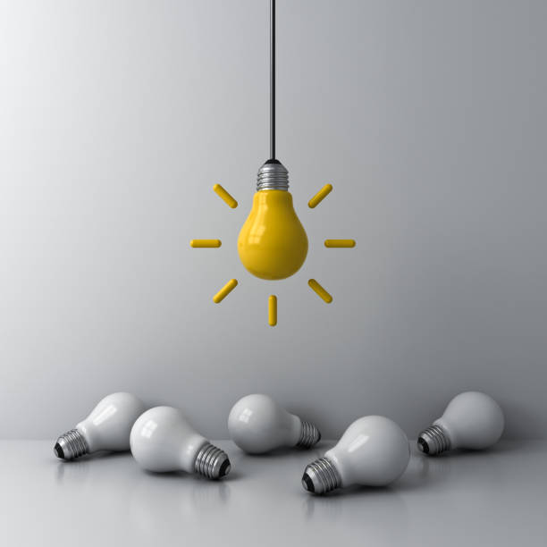 istock Idea hanging bulb standing out from the crowd the dim unlit white bulbs on white background business creative idea concepts 1223395172