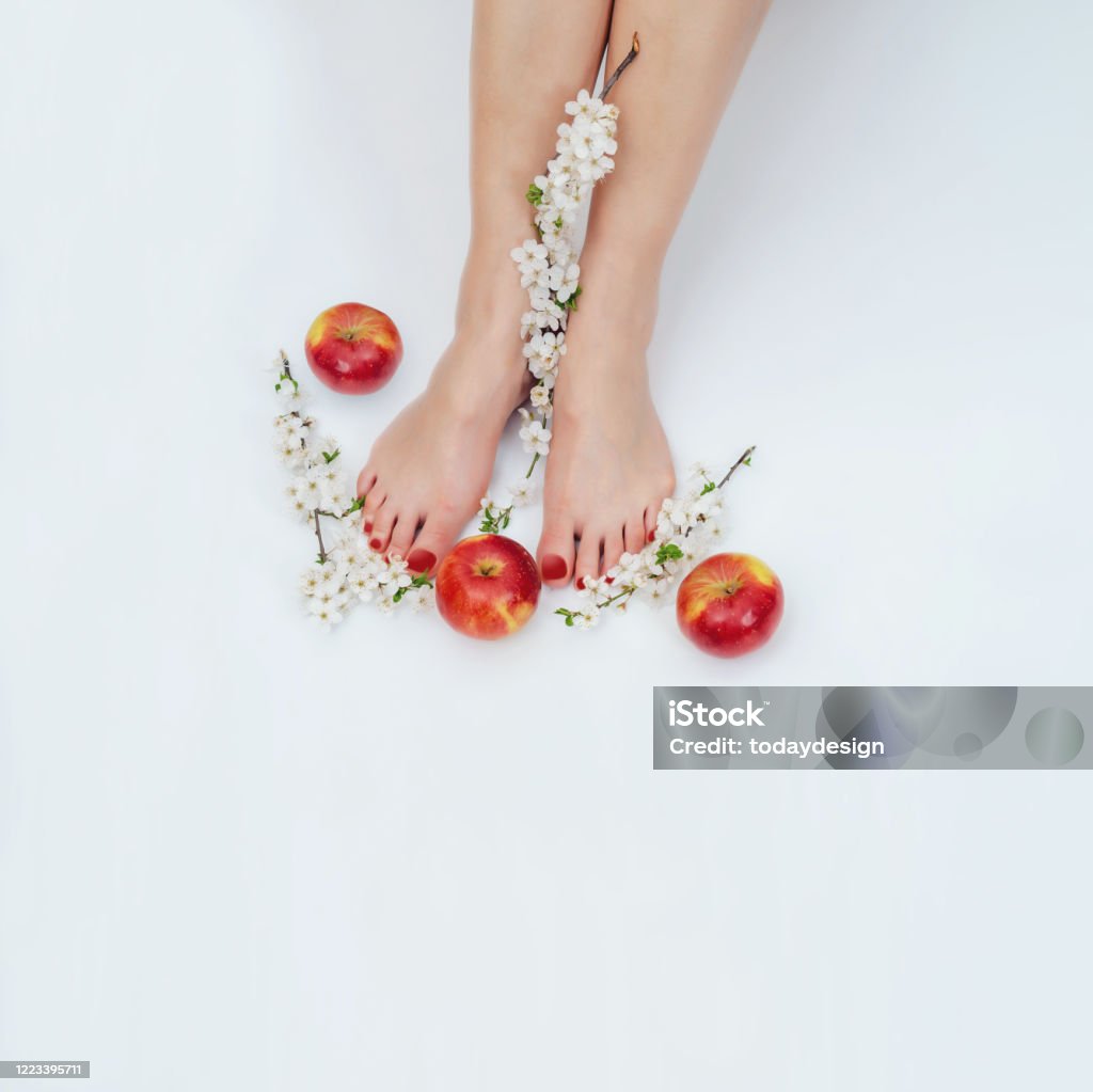 Female Bare Feet On White Background With Apples And Flowers On Cherry ...