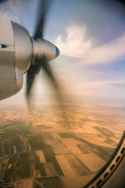 View from the plane's illuminator on a rotating propeller. Flying at high altitude.