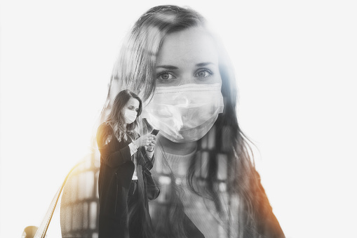 Double exposure photo effect of a woman wearing a protective face mask during the COVID-19 pandemic.