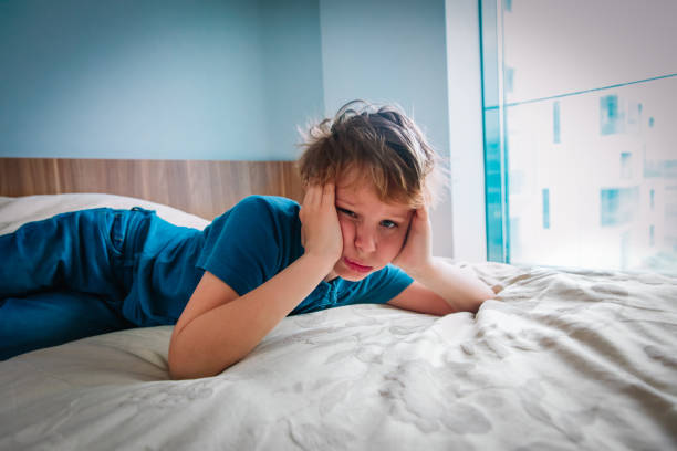 istock boy feeling anxiety and stress, kid staying home 1223398093