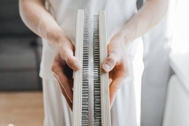 Close-up of man holding in hands bed of nails at morning yoga practice. Man holding in hands bed of nails and preparing for morning yoga practice. Mindfulness and alternative medicine concept. bed of nails stock pictures, royalty-free photos & images