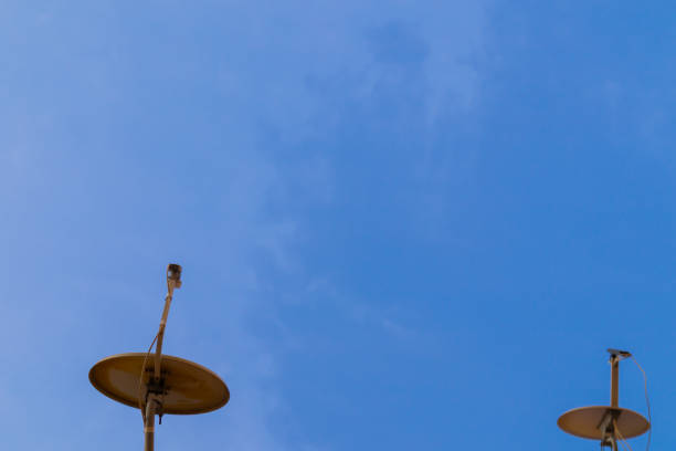 istock Two satellite antennas with space on blue sky. Background. 1223399396