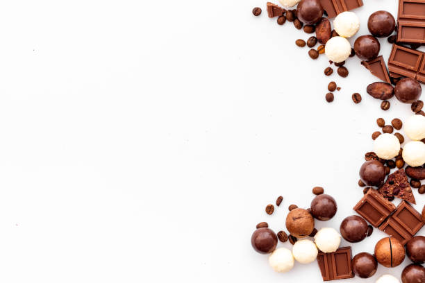 istock Chocolate background on white table top-down frame. Sweet desserts concept. Copy space 1223400671