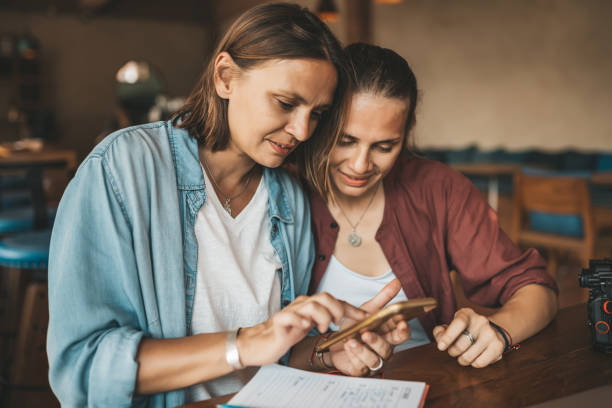 istock Two young girls using smart phone at the cafe. 1223400944