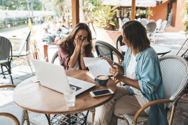 istock Two women discussing business projects in a cafe while having coffee. 1223401022