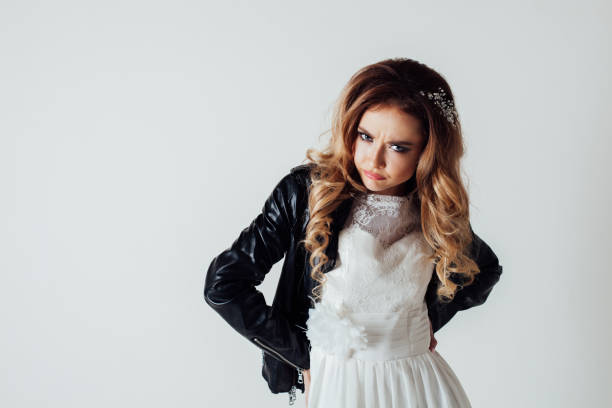 istock bride in wedding dress and leather jacket 1223403109