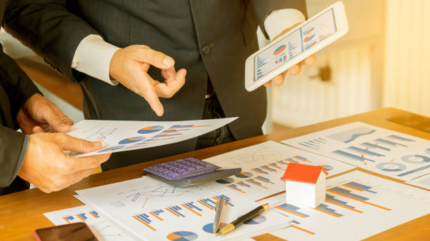 istock Meeting of business groups that started creative colleagues and working on new office project plans, entrepreneurs, brainstorming, teamwork, plan analysis, professional investors, real estate concept 1223403151