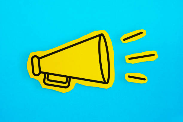 istock Megaphone drawing on the cut yellow paper makes announcement. 1223405546