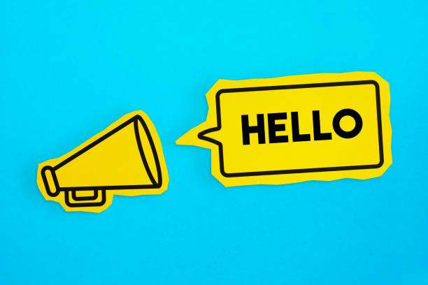 istock Megaphone drawing on the cut yellow paper makes “Hello” announcement. 1223406061