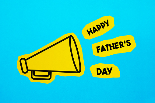Megaphone drawing on the cut yellow paper makes Happy Fathers Day announcement. Horizontal composition with copy space. Communication Concept.