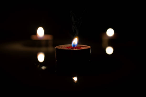 istock Three candles are lit in the dark space 1223407118