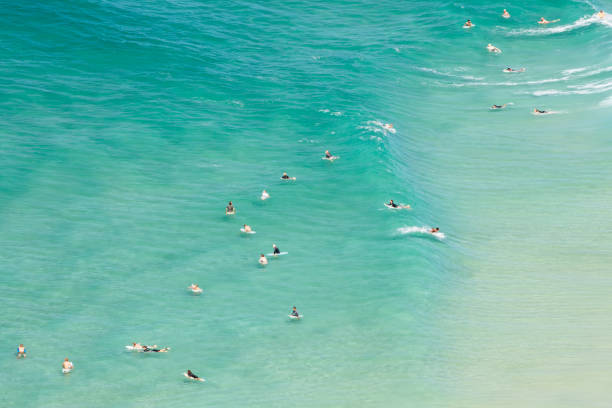 australian coastline with surfers in byron bay - cabarita beach imagens e fotografias de stock