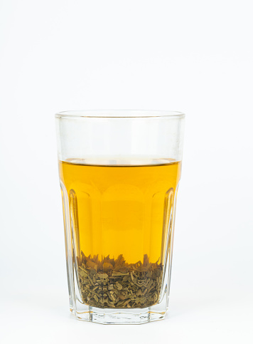 Cup of Tea and teapot, spoon, sugar, on a light wooden background