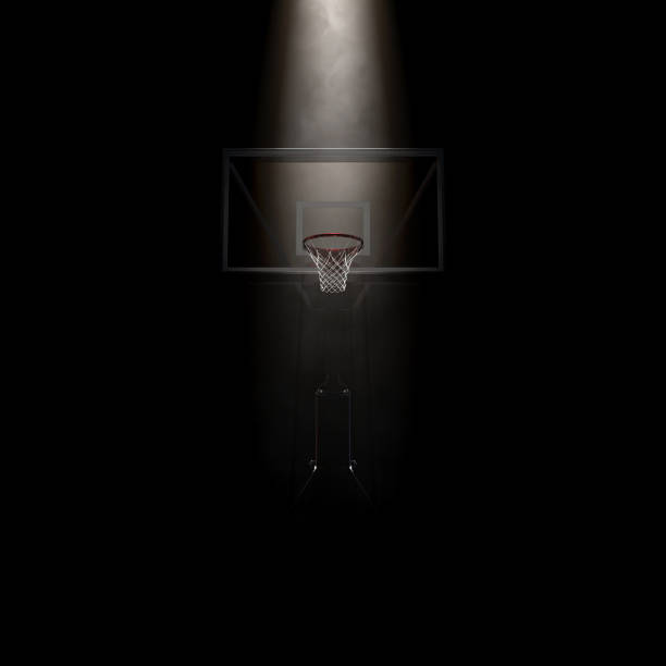 Basketball Hoop Spotlight A concept showing a regular basketball hoop dramatically spotlit from above on an isolated dark background - 3D render basketball hoop stock pictures, royalty-free photos & images