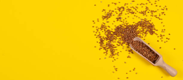 istock Buckwheat groats in a plate on a yellow background. 1223412971