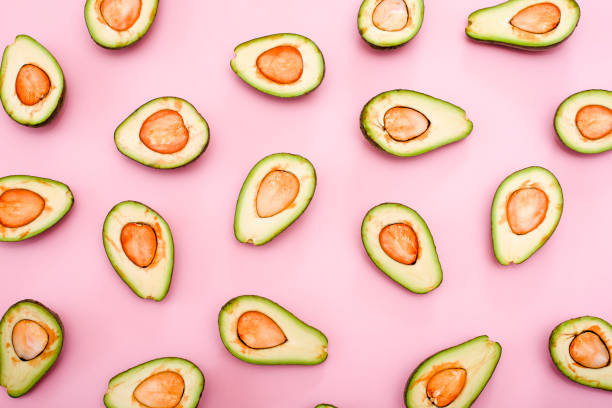 istock Avocado natural color and condition divided in half on a pink background. 1223413006