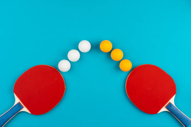 istock Ping pong racket and ball on blue background 1223413398
