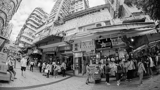 Sham Shui Po, Hong Kong - 07 May, 2020 : People walking across Apliu Street. Apliu Street Flea Market is a popular jumble of electronics and accessories.