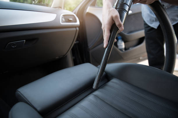 istock Man Using Car Vacuum Cleaner To Tidy Car. 1223414664