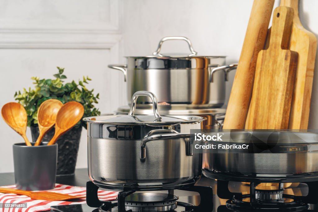 Clean saucepan on a gas stove in kitchen Clean saucepan on a gas stove in kitchen. Close up. Cooking Pan Stock Photo