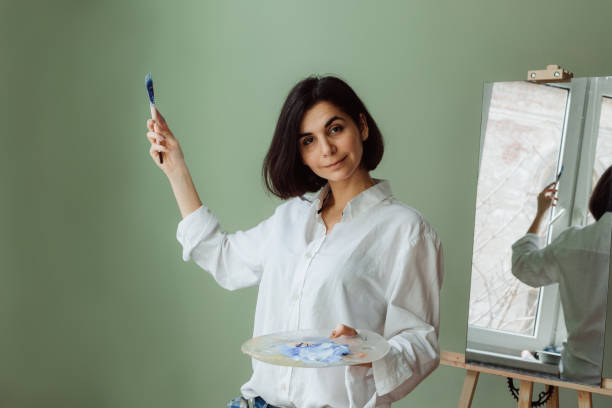 istock Woman with paintbrush and palette draw 1223415067