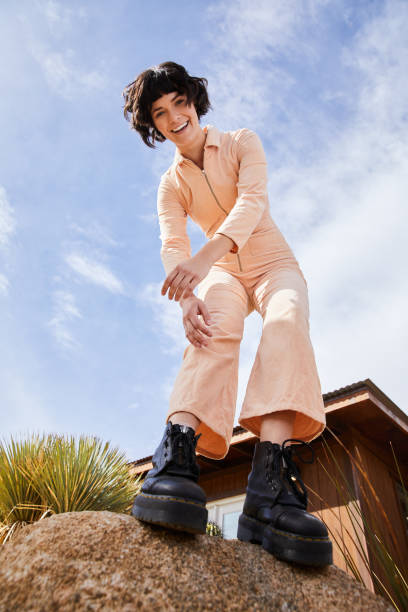 istock Stylish young woman smiling while standing outside on a rock 1223418363