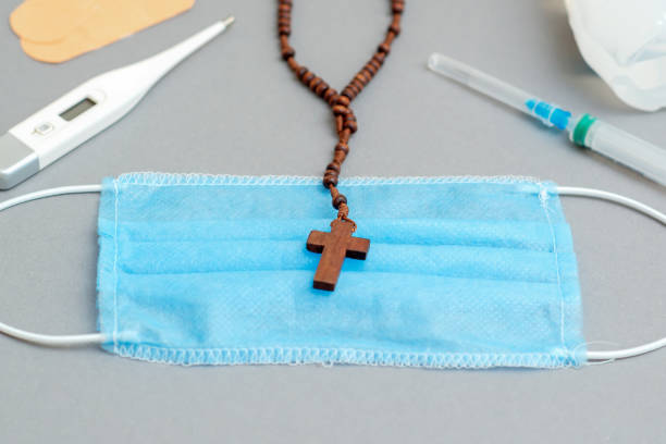 istock Medical mask with catholic cross. 1223421073