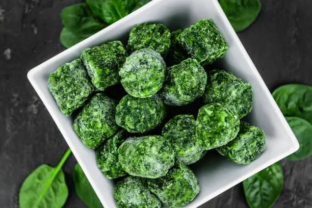 Frozen spinach cubes as detailed close up shot (selective focus)