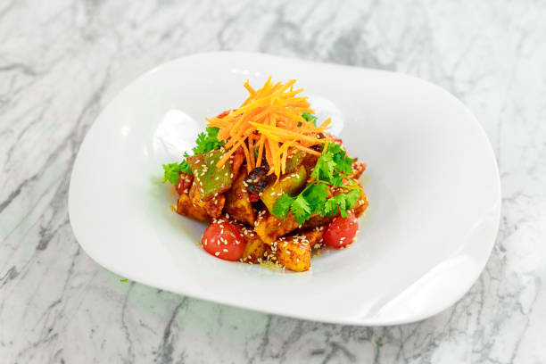 istock fried tofu with sesame seeds and vegetables on a white plate 1223422907