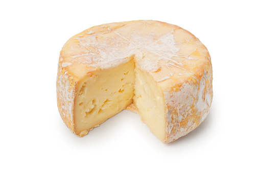 Studio shot of soft camembert style cheese cut out against a white background