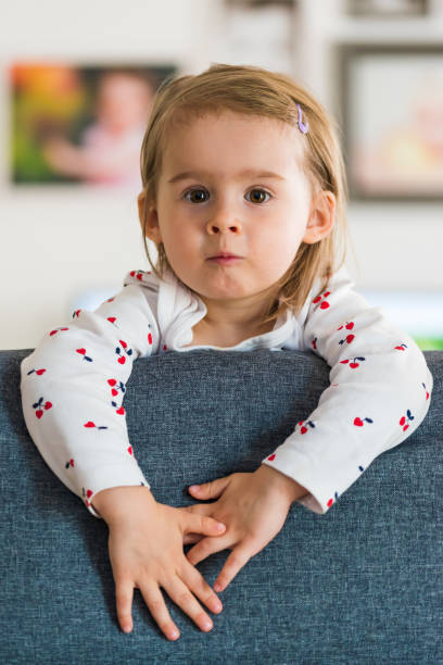 two year old girl with big eyas portrait, indoor shoot with natural light - eyas imagens e fotografias de stock
