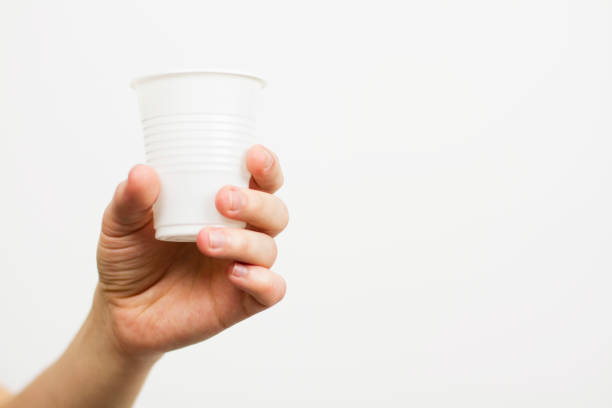 istock female male hand holding a white plastic cup isolated 1223423555