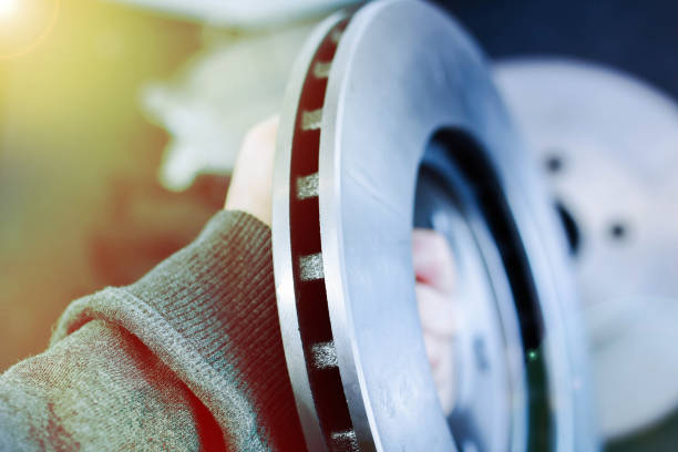 istock ventilated brake disc is held by a mechanic. 1223426189