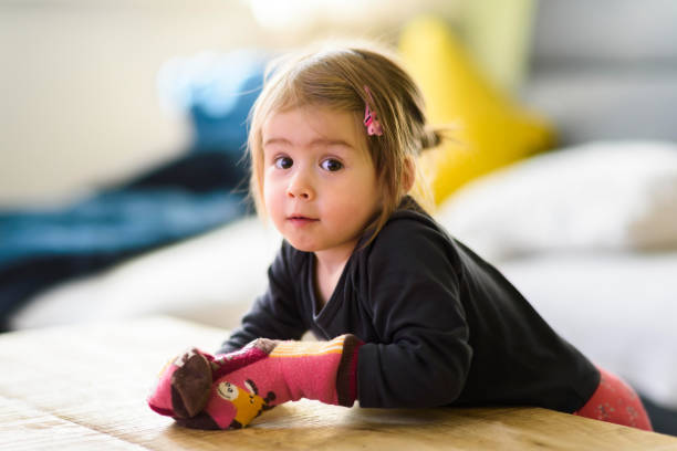 two year old girl with big eyas portrait, indoor shoot with natural light - eyas imagens e fotografias de stock