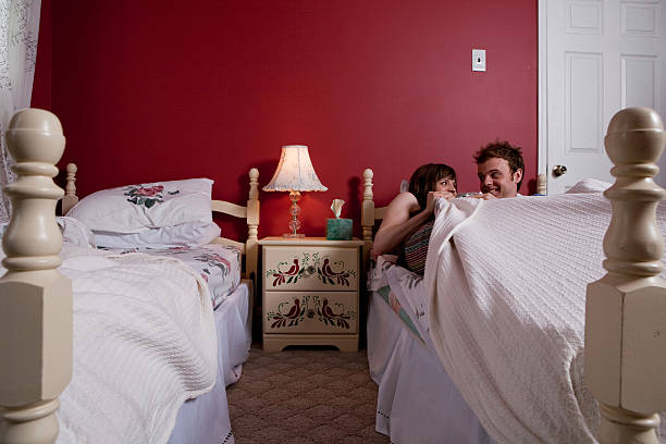 Young couple sharing single bed  twin bed stock pictures, royalty-free photos & images