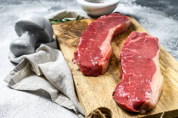 istock Raw ramp steak, fresh meat, marbled beef. Dark background. Flat lay 1223430299