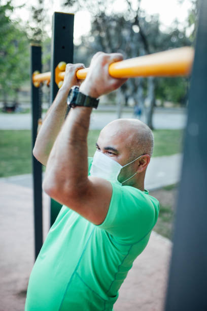 istock Man working out in a park wearing protect mask 1223430508