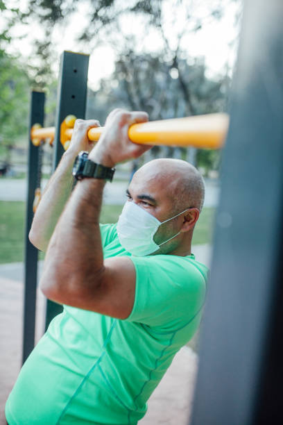 istock Man working out in a park wearing protect mask 1223430600