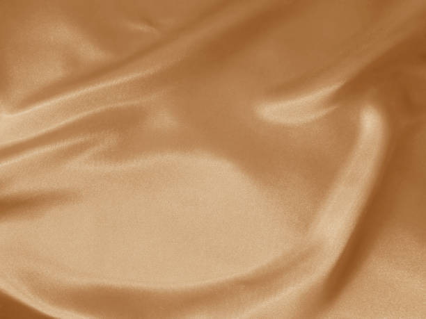 istock Shiny peachy crumpled fabric background 1223430645
